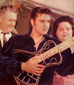 Elvis Presley pictures with his guitar and parents